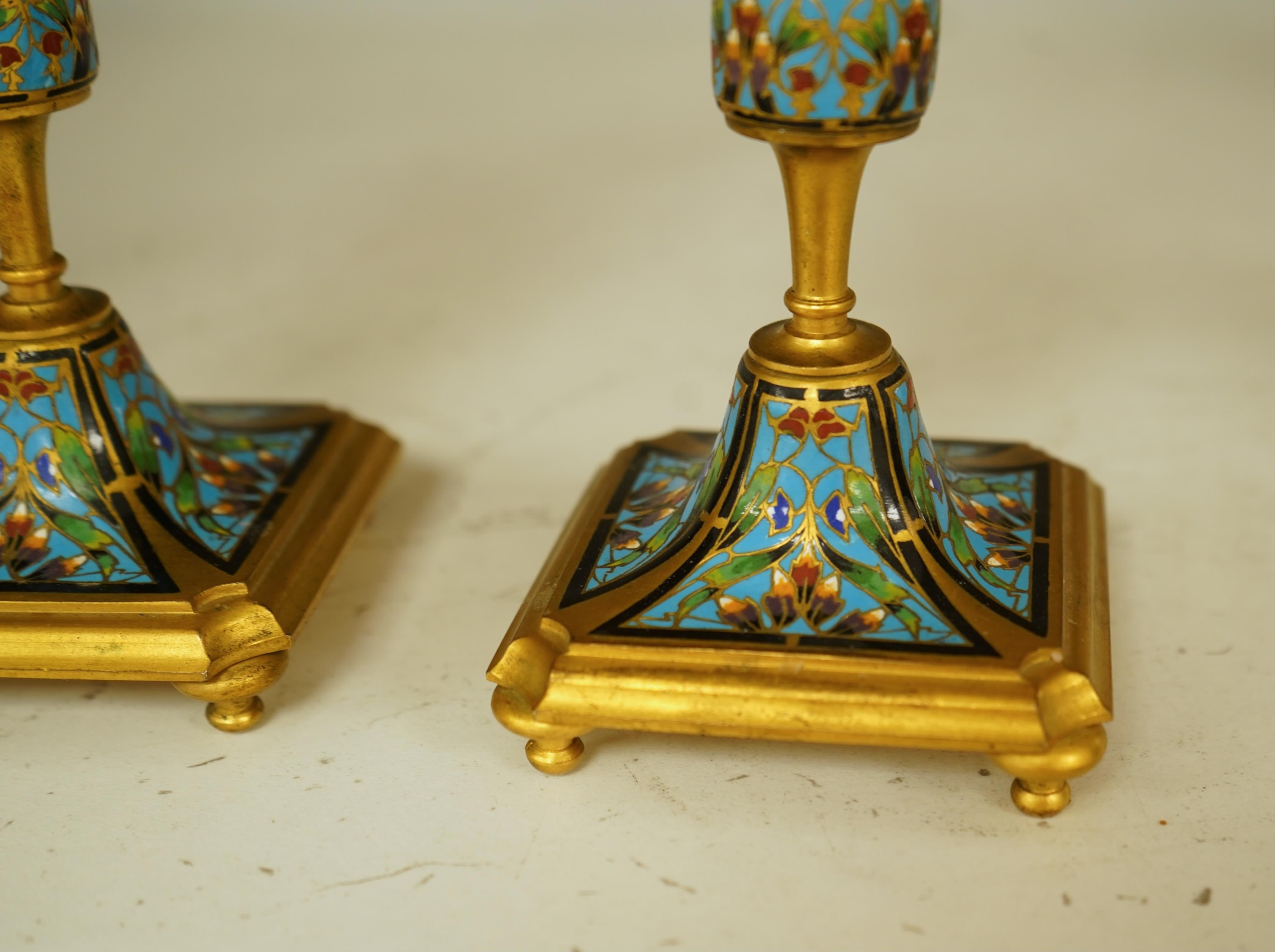 A pair of late 19th century French champleve enamel and ormolu candlesticks, 17cm